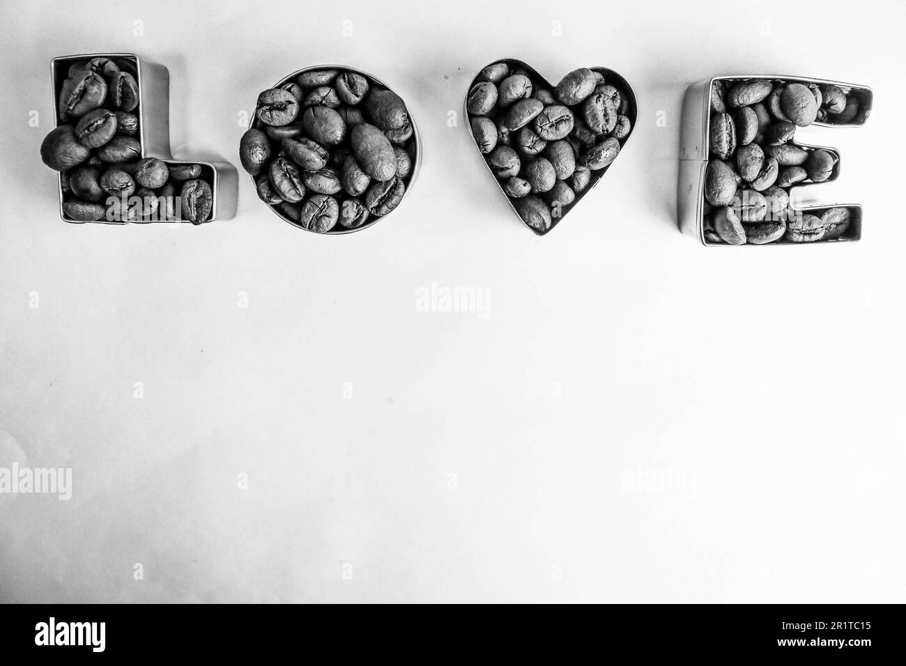 Beautiful texture with the word love for valentine's day inscription made from roasted selected brown natural aromatic Arabica coffee beans, robusta C Stock Photo