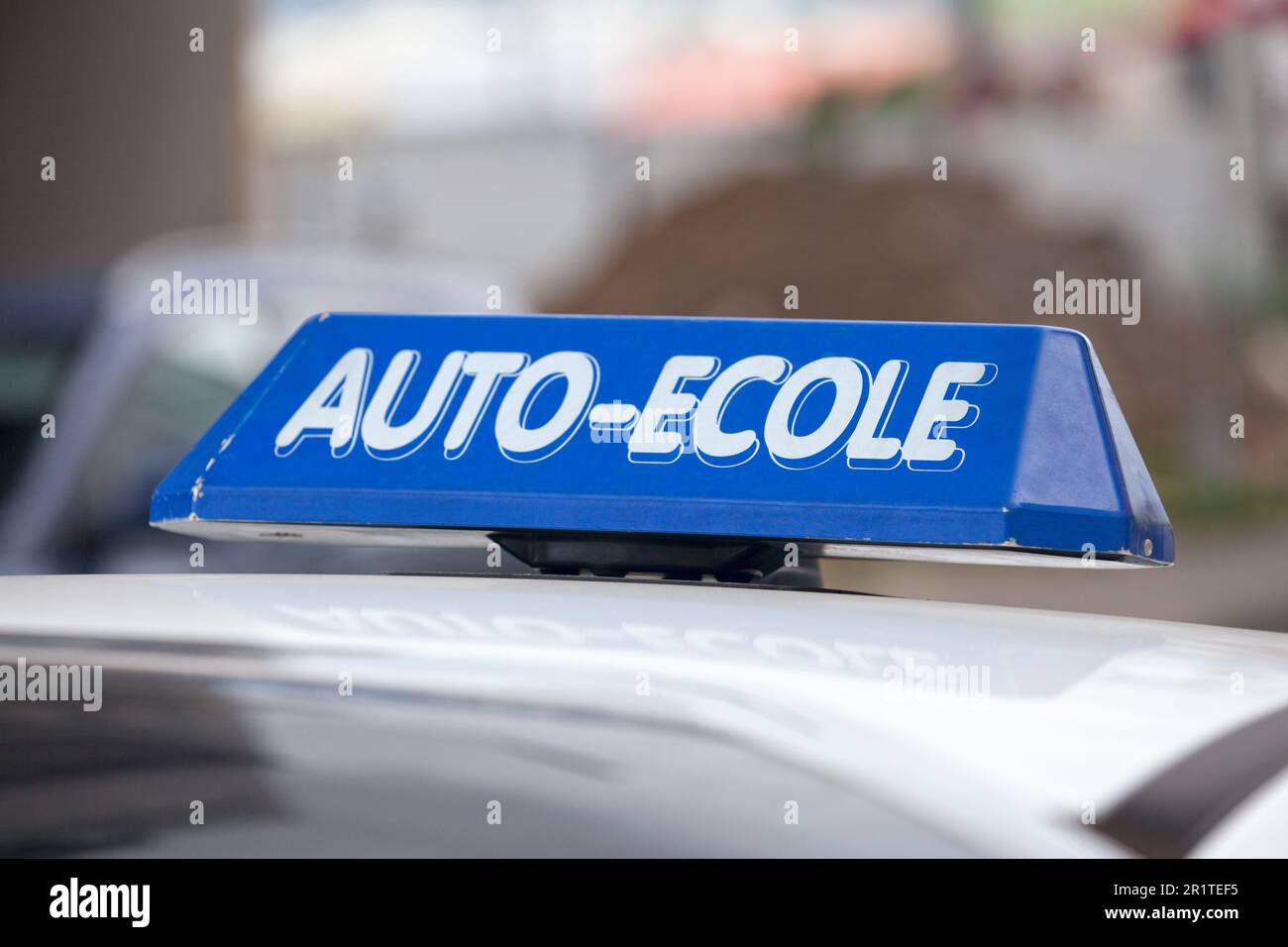 Blue car roof sign with written in it in French 'Auto-Ecole', meaning in English 'Driving school'. Stock Photo