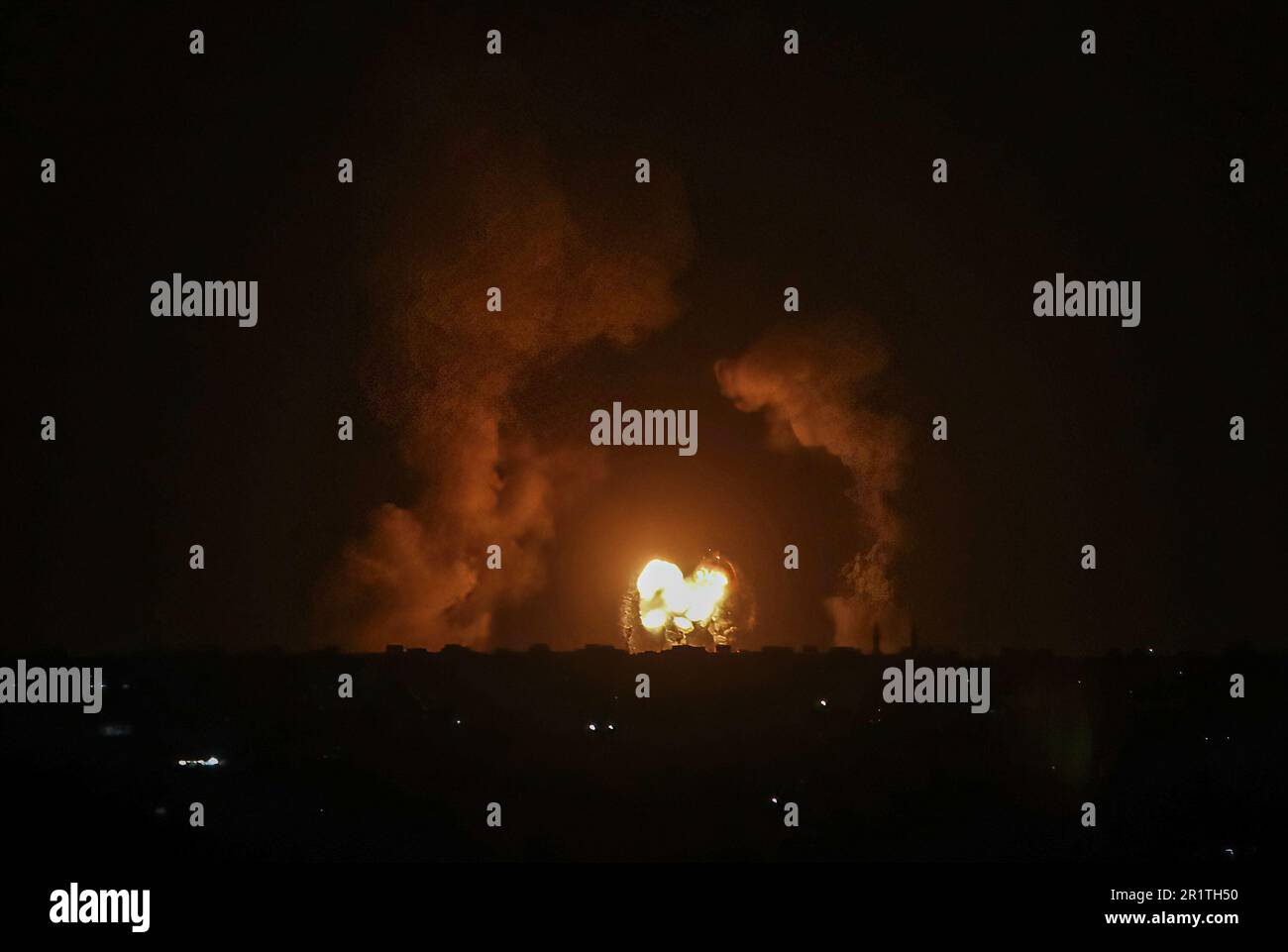 Gaza, Palestine. 13th May, 2023. Flames and smoke rise in the aftermath of the Israeli air raids in Khan Yunis, in the southern Gaza Strip, an hour after the truce entered into force. Credit: SOPA Images Limited/Alamy Live News Stock Photo