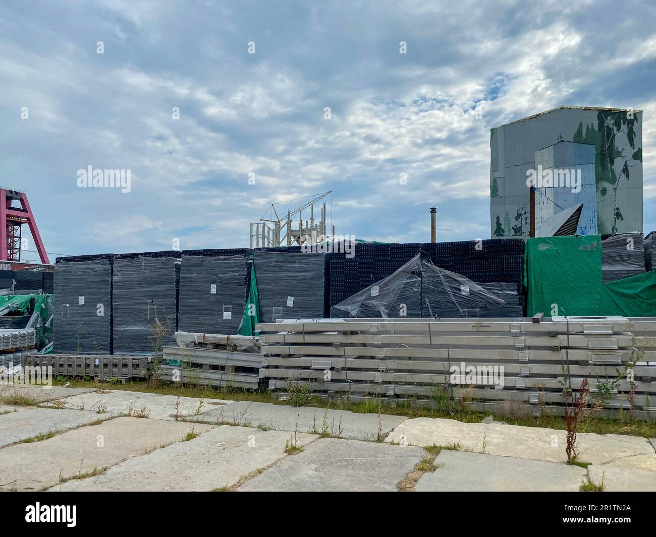 Boxes with equipment at the construction site of a factory in an open
