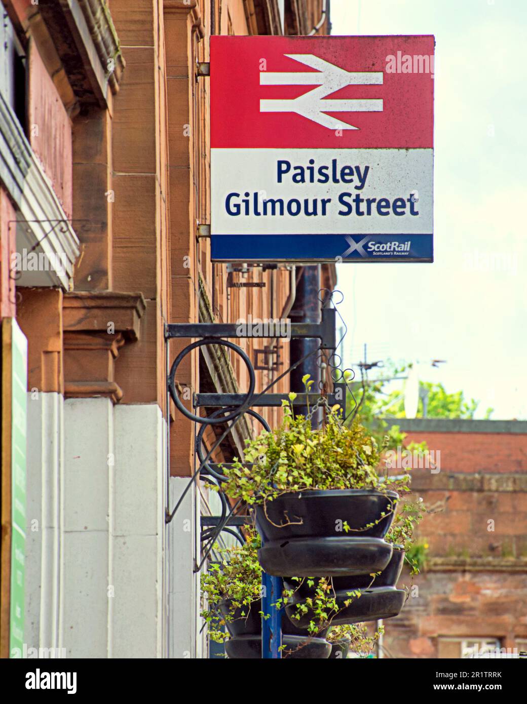 paisley gilmour street railway station with flower baskets sign Stock Photo