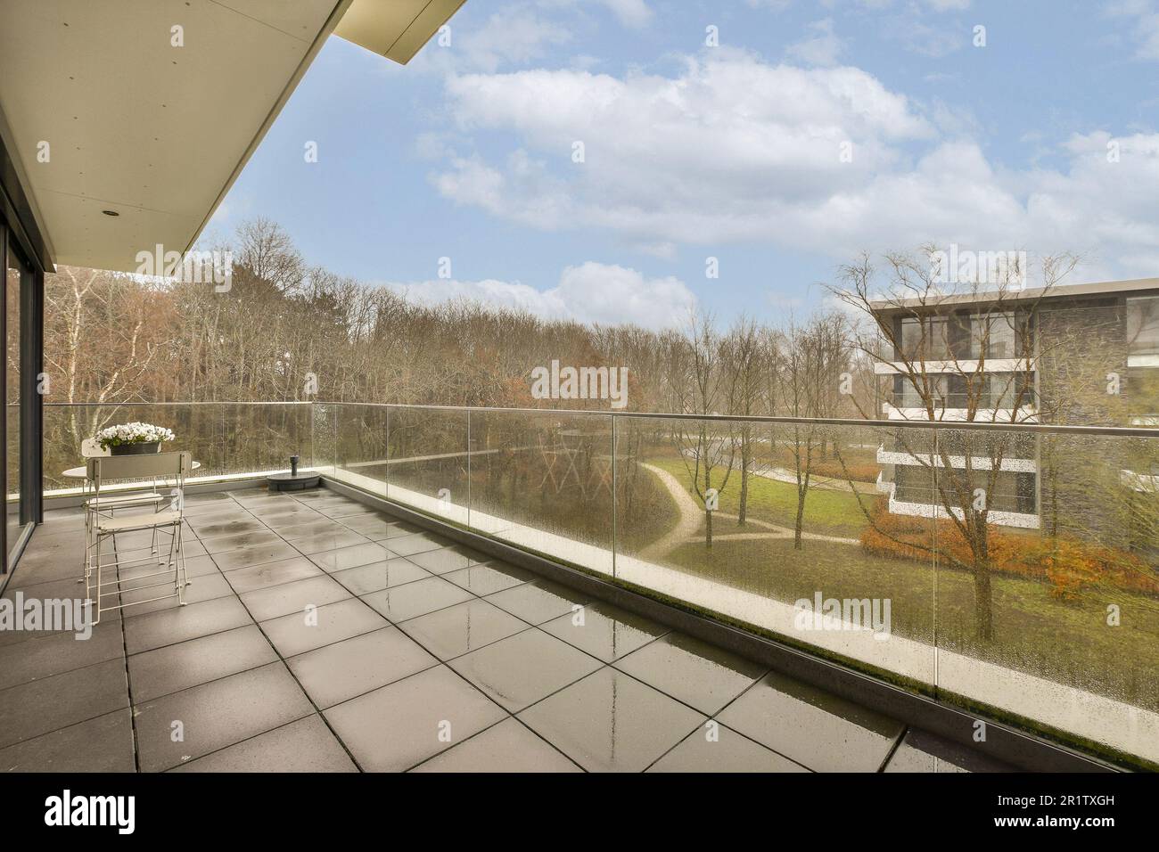 an outside area with glass railings and trees on the other side of the ...