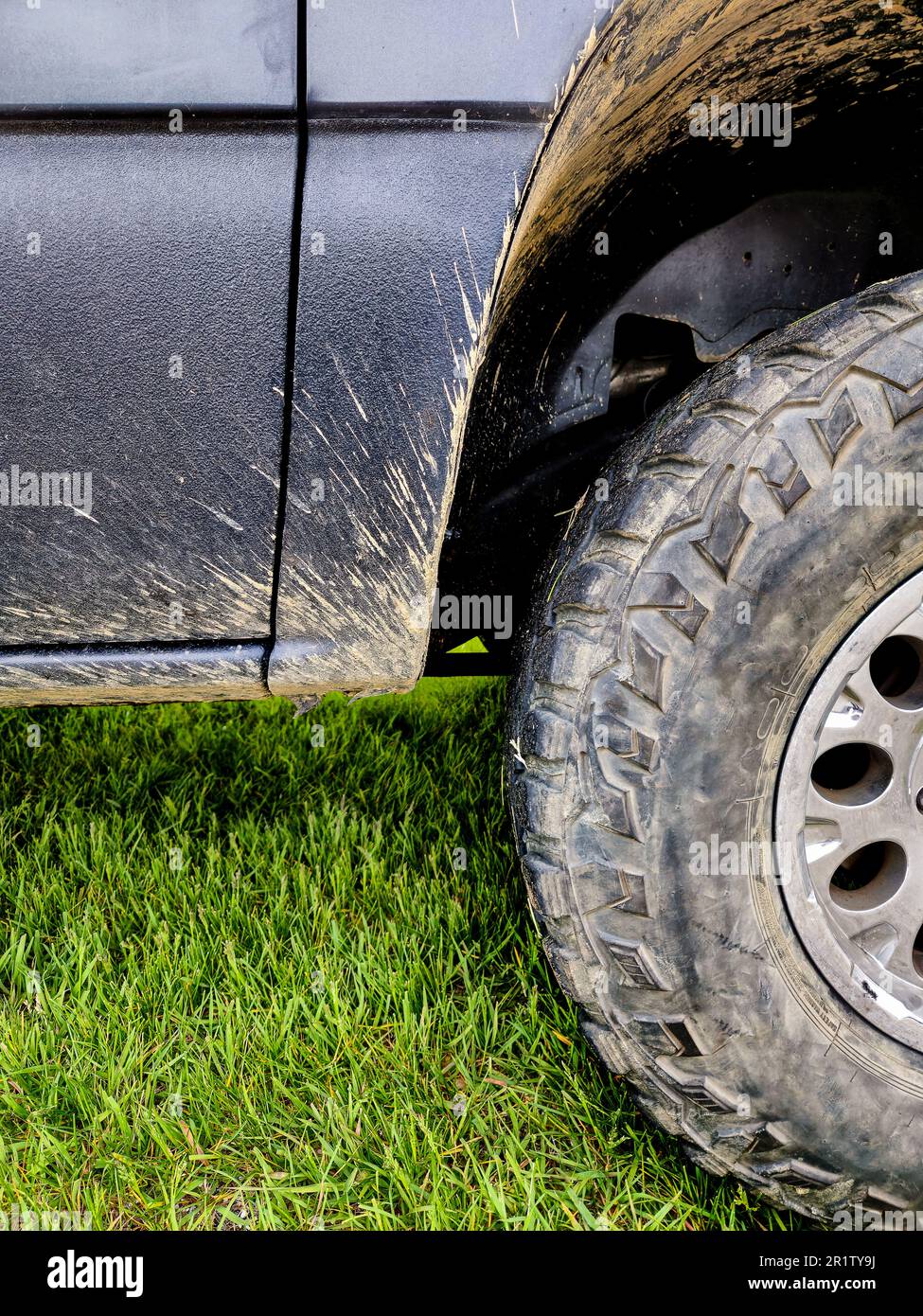Closeup of dried mud splashed on the truck tire and wheel well Stock Photo