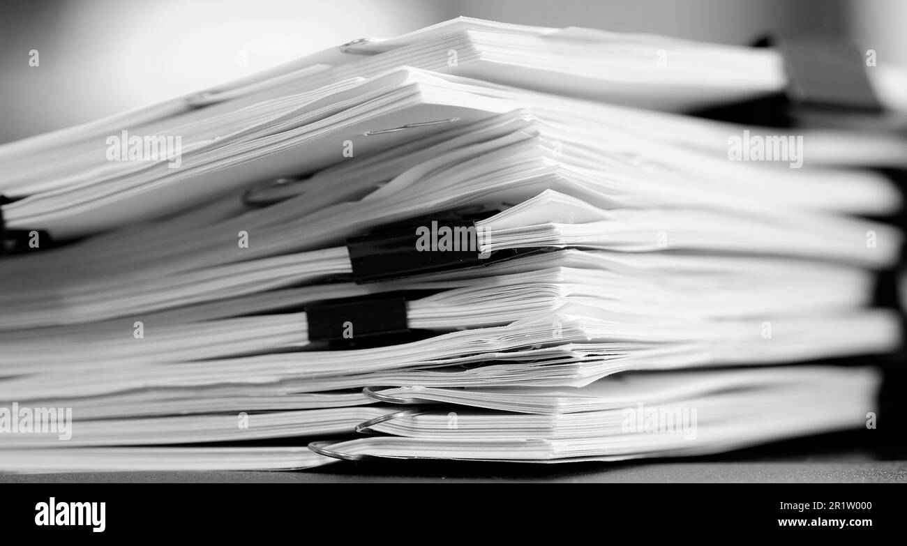 Pile of papers with binder clips paperclips business for organizing on