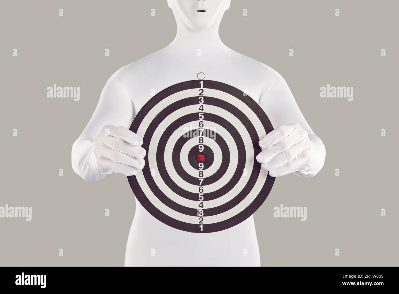 Anonymous person in white bodysuit costume holding shooting target board in hands Stock Photo