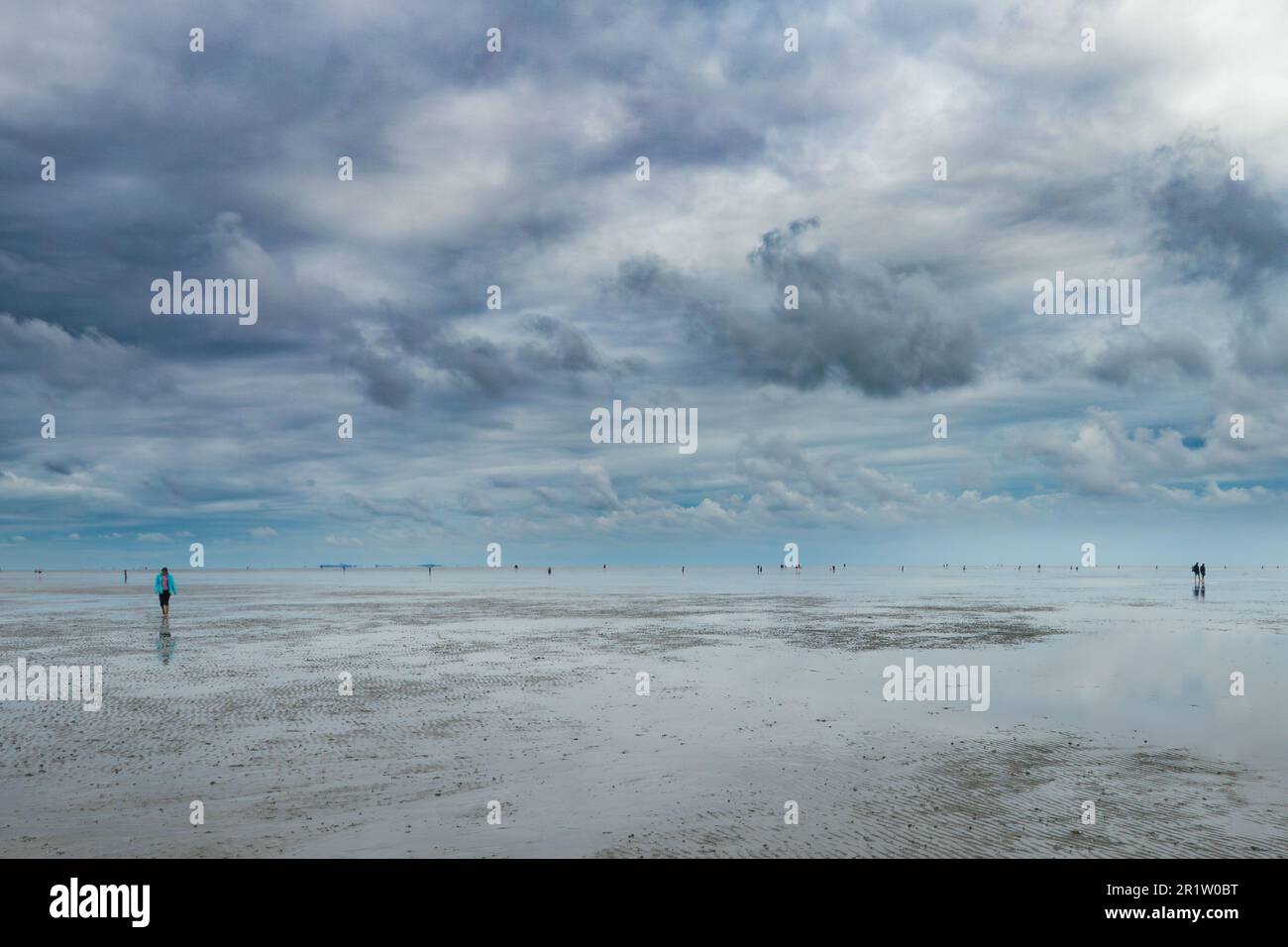 Sand and clouds on low tide on the Wadden Sea. Stock Photo