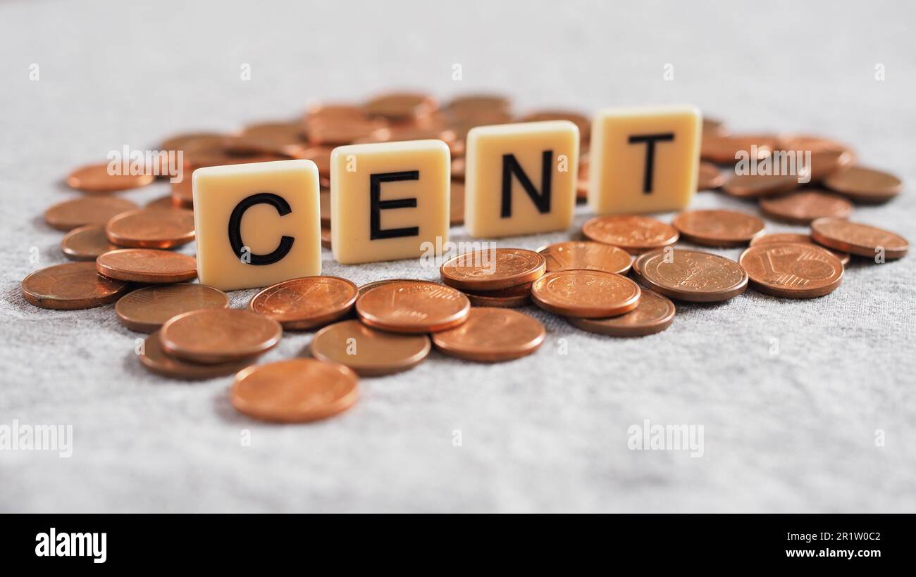 cent in letters surrounded by one euro cent coins on gray background Stock Photo