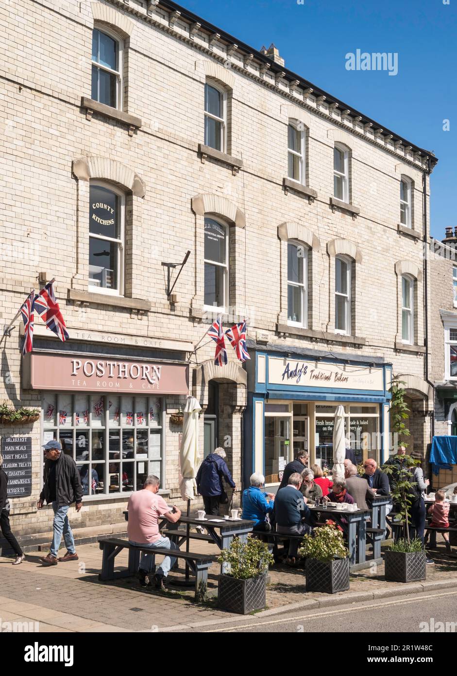 People sitting outside the Posthorn tearoom in Leyburn, North Yorkshire, England, UK Stock Photo