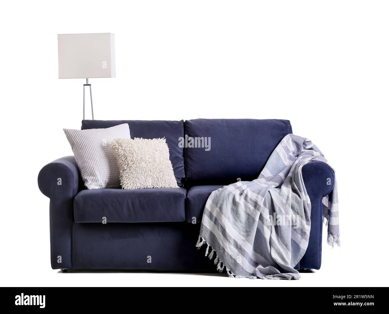 Dark blue sofa with plaid and cushions isolated on white background