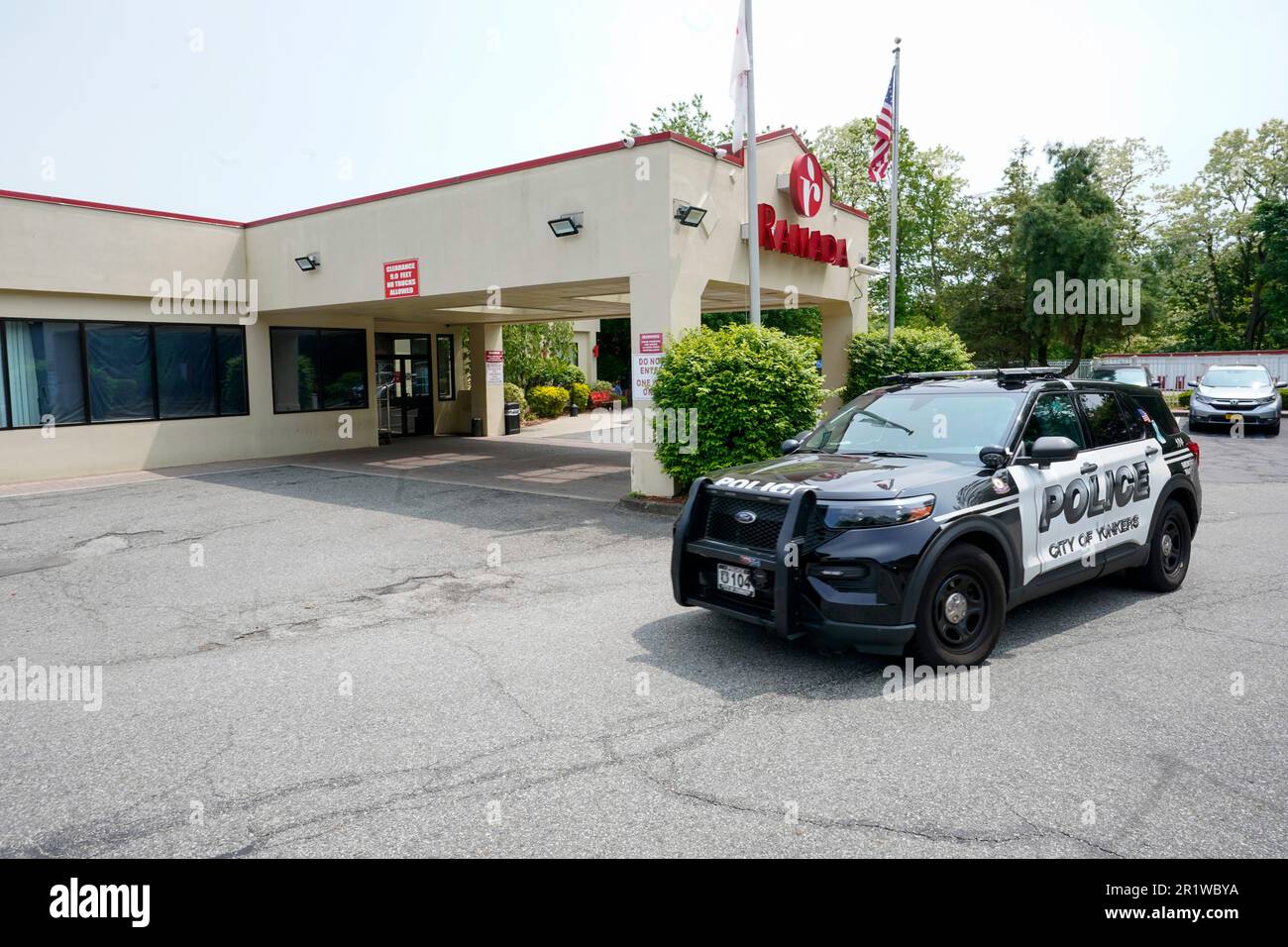 A Yonkers police car drives through the Ramada parking lot in Yonkers