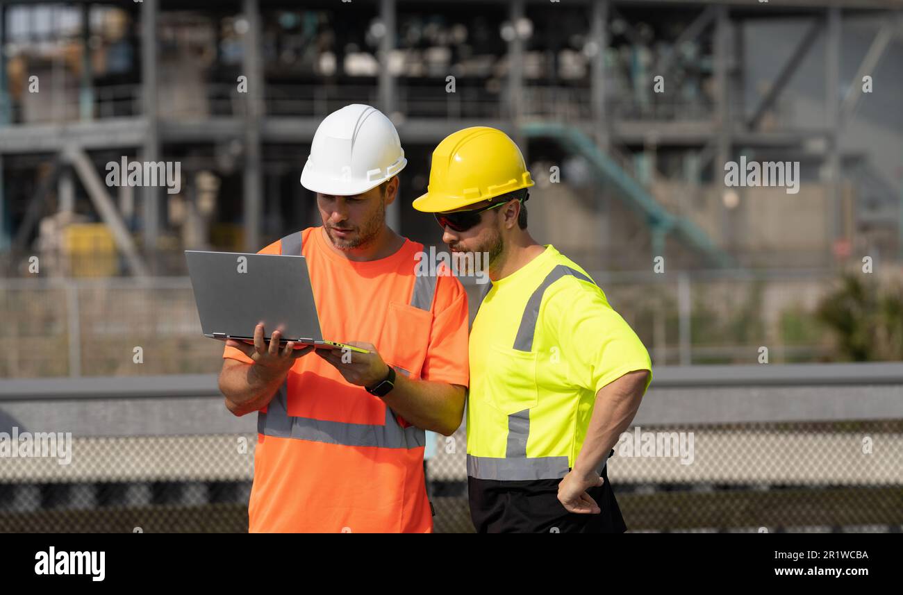 Supervisor Man concentrated supervisor men have construction project on laptop. photo ...