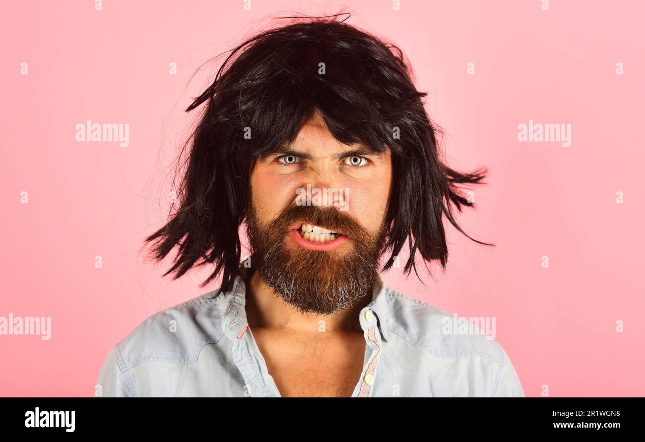 Bearded man in black wig. Portrait of angry man with beard and mustache in black wig. Evil guy with black hair. Bearded male in wig. Man in periwig Stock Photo