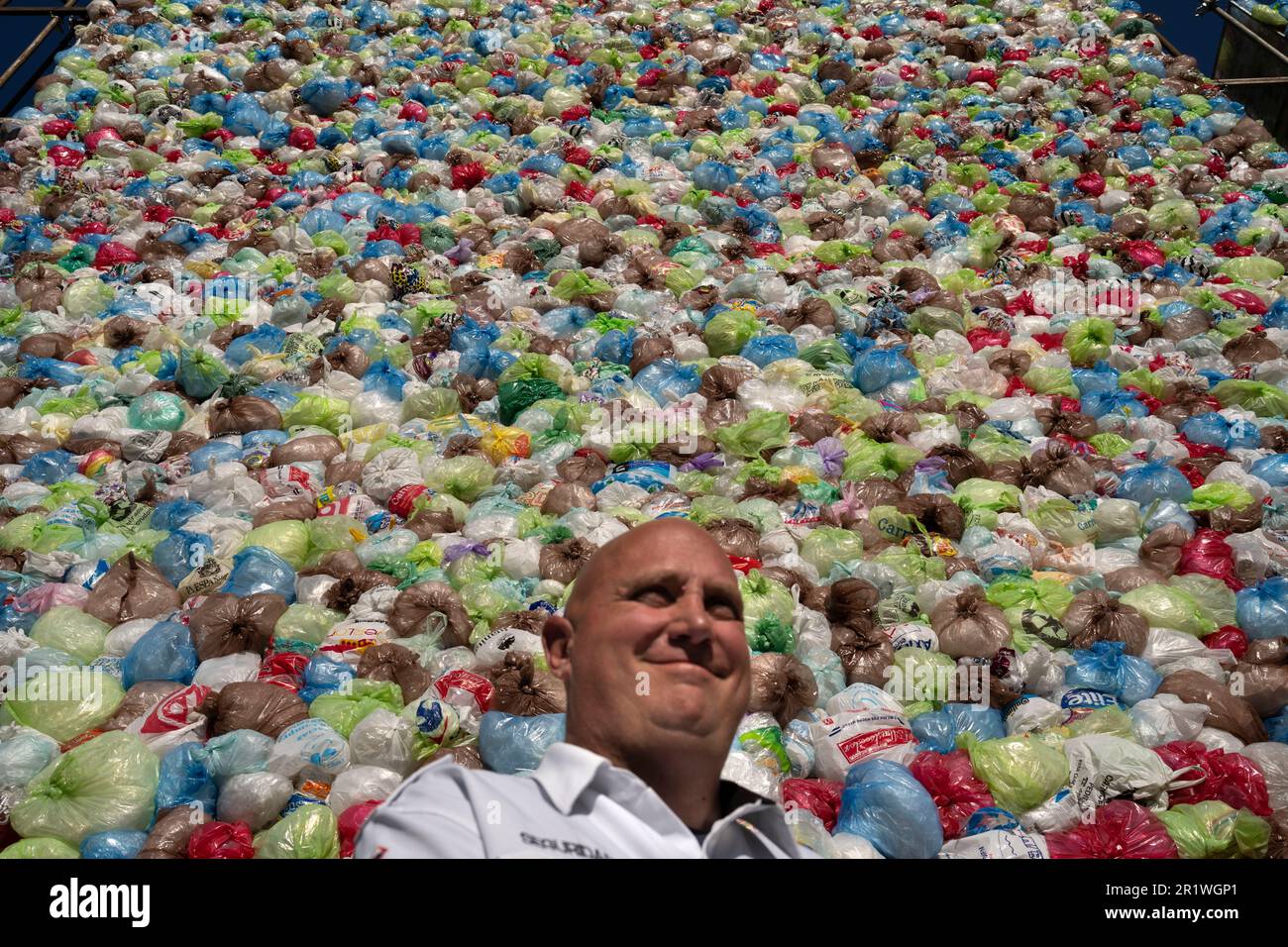 A private security guard stands next to an artistic intervention at the ...