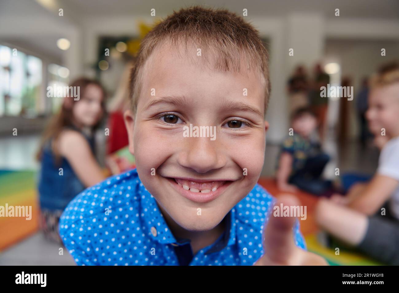 Portrait photo of a smiling boy in a preschool institution having fun ...