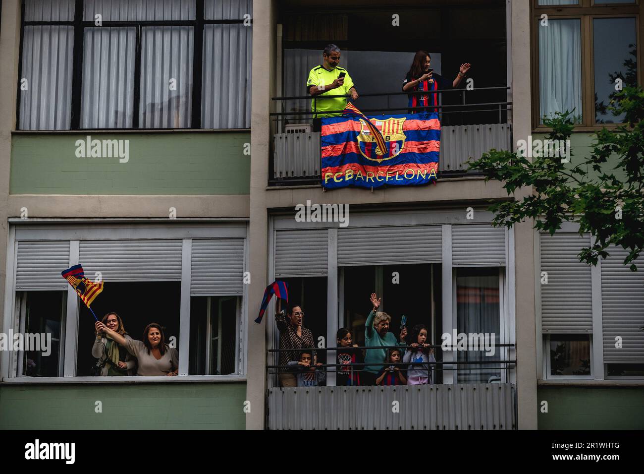 Barcelona, Spain. 15th May, 2023. Supporters gather to their windows and balconies to see the FC Barcelona's open top bus victory parade after the male and female team win the Spanish football league. Credit: Matthias Oesterle/Alamy Live News Stock Photo