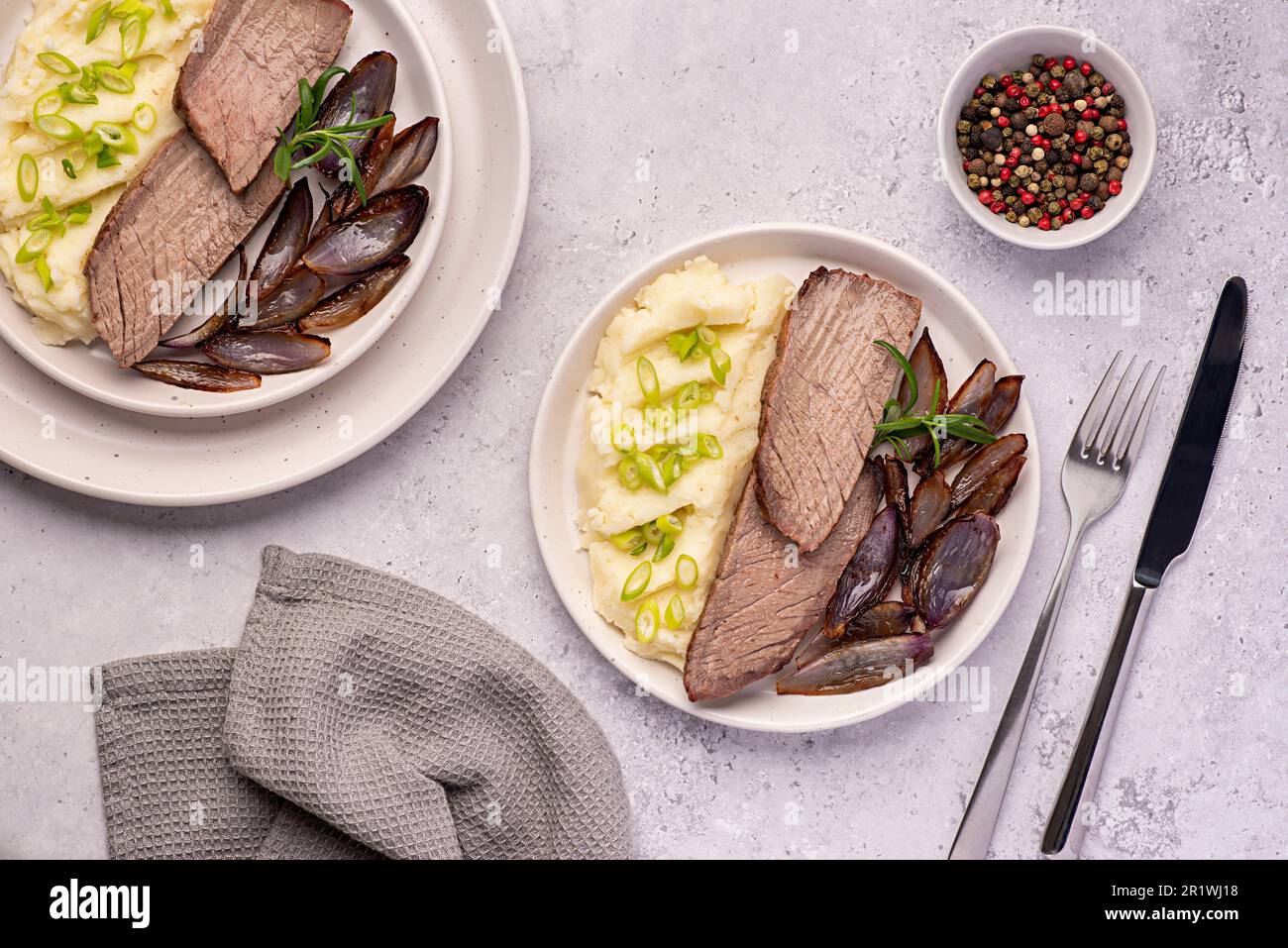 Food photography of roasted beef, joint, fillet, mashed potatoes, onion, rosemary, garlic