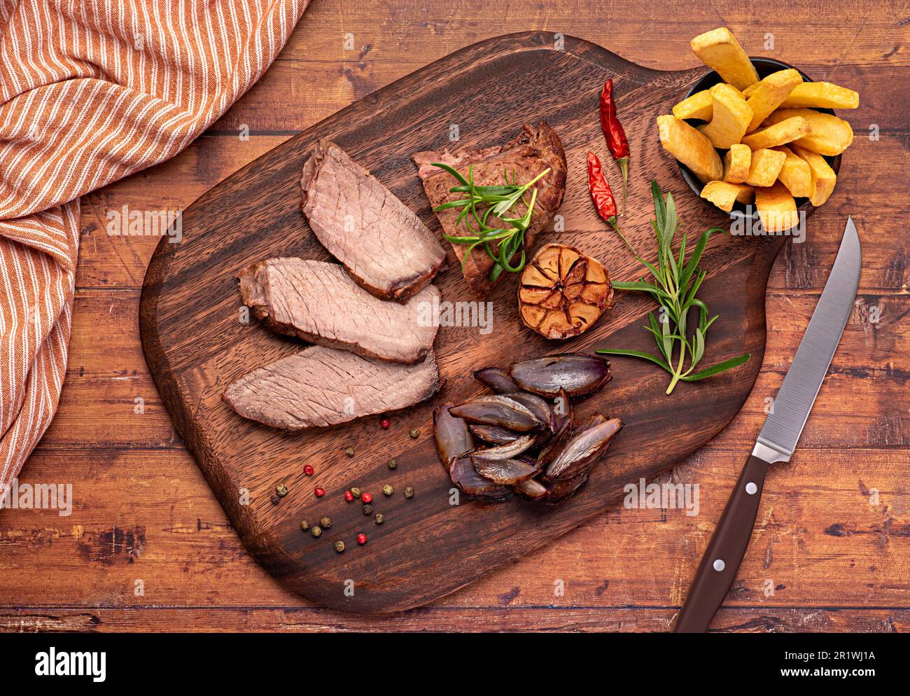 Food photography of roasted beef, joint, fillet, fries, chips, onion, rosemary, garlic, pepper
