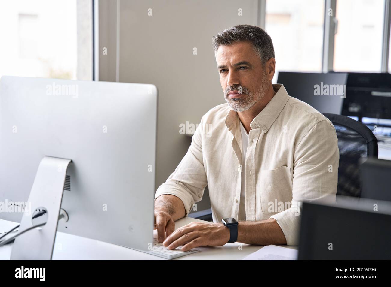 Mature Latin business man ceo trader using computer working in modern ...
