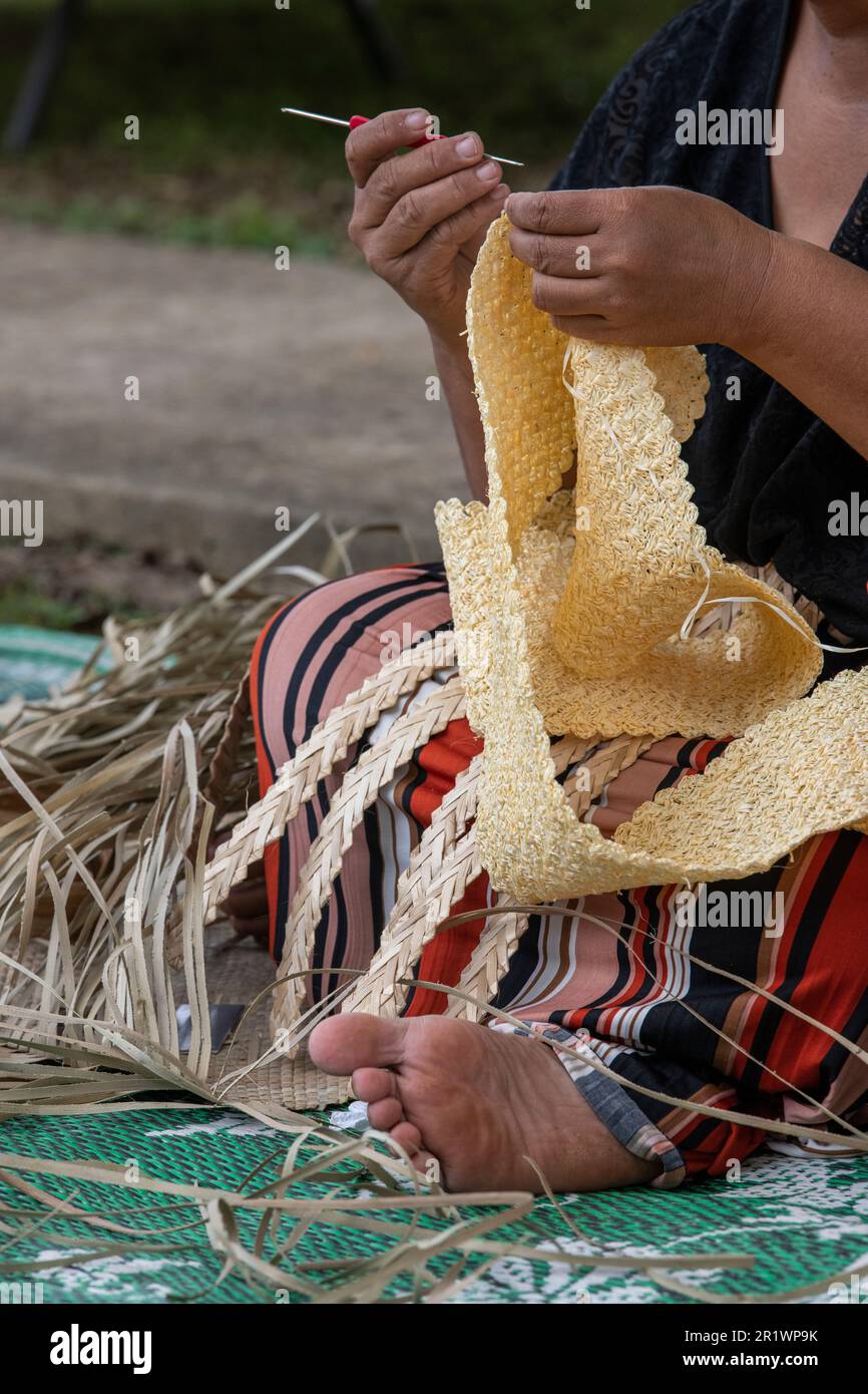 Kingdom of Tonga, Neiafu. Local woman crocheting straw. Stock Photo