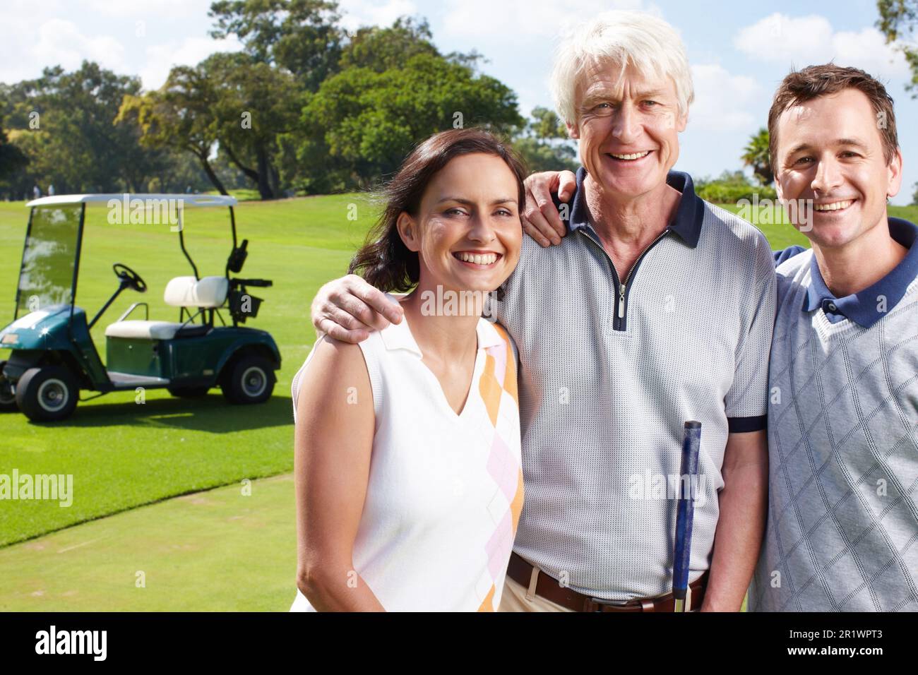 Connected by a mutual love of golf. Smiling golfing companions on the green with their golf cart in the background. Stock Photo