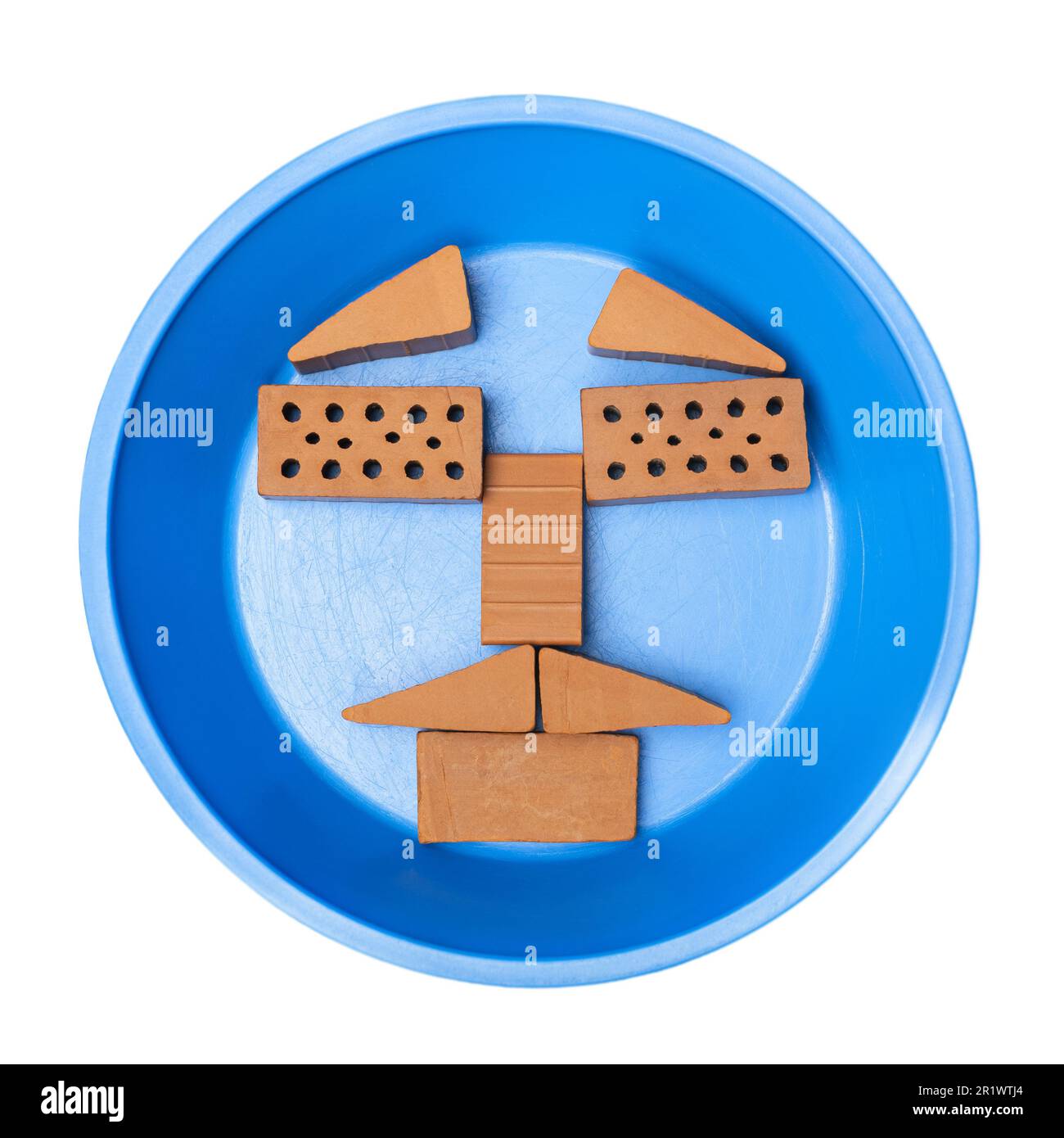 Face like form made from Mini ceramic bricks on construction equipment,  Construction  wall brickwork  concept. Isolated PNG Stock Photo