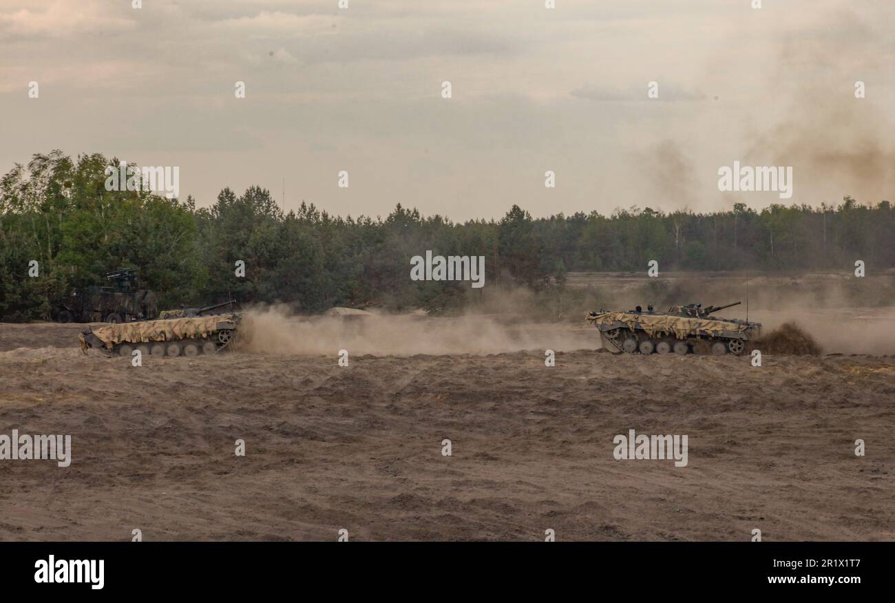 Polish soldiers assigned to the 19th Mechanized Brigade maneuver a PT-91 tank while participating in a combined arms rehearsal during Anakonda23 at Nowa Deba, Poland, May 13, 2023. Anakonda23 is Poland's premier national exercise that strives to train, integrate and maintain tactical readiness and increase interoperability in a joint multinational environment, complimenting the 4th Inf. Div.'s mission in Europe, which is to participate in multinational training and exercises across the continent while collaborating with NATO allies and regional security partners to provide combat-credible forc Stock Photo