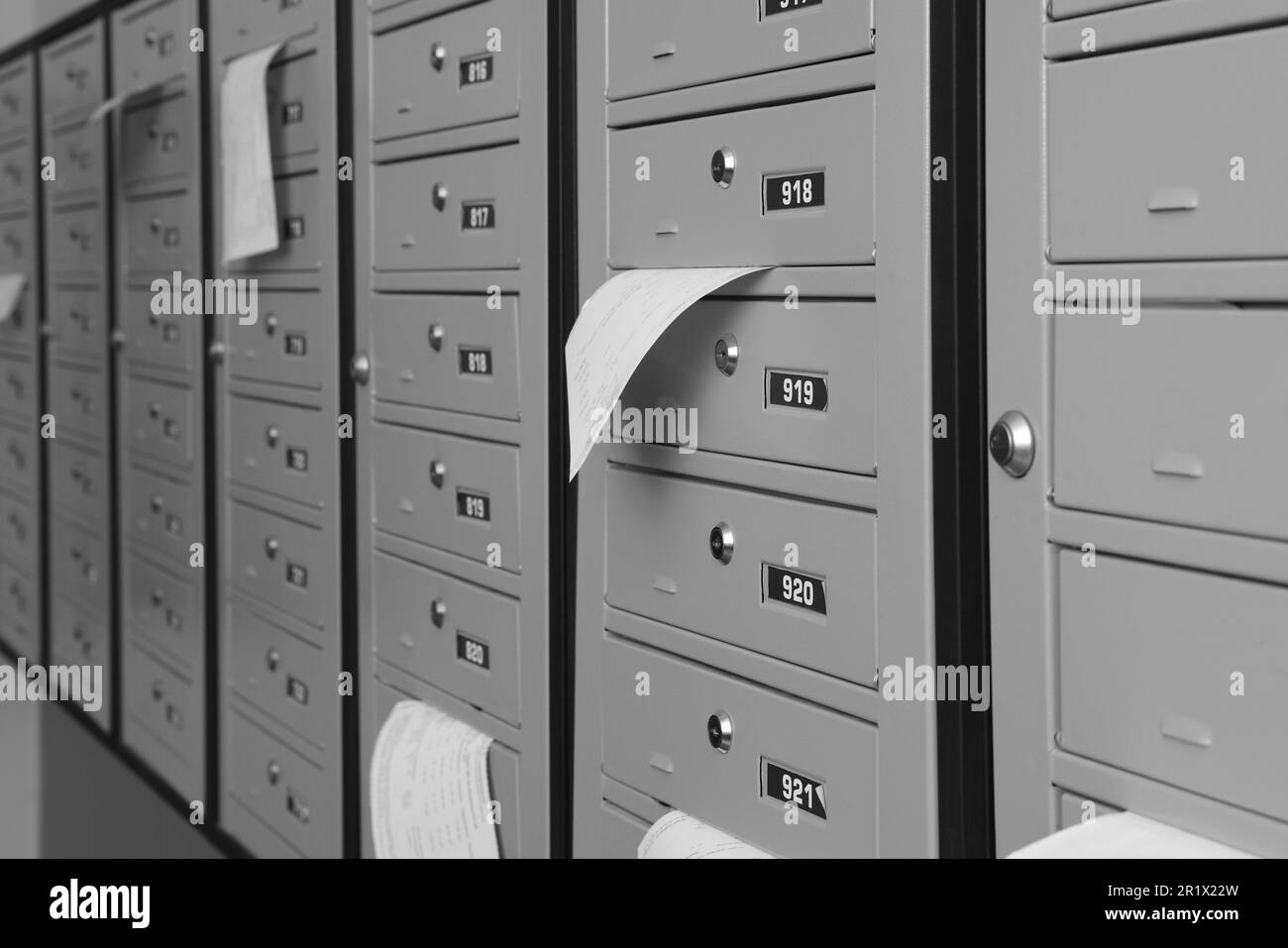 Closed grey metal mailboxes with receipts indoors Stock Photo Alamy
