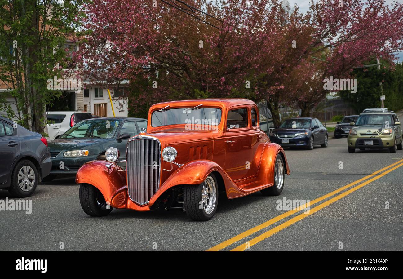 Vintage Car Show, showing orange 1930s-1940s Chevrolet Coupe, front view of a car driving on a street. Travel photo, nonbody, street photo-Vancouver C Stock Photo