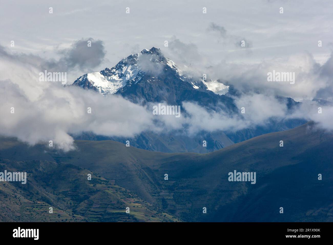 A view of a spectacular snow capped peak in the Andes Mountain range as seen from Maras in Peru. Maras is a town in the Sacred Valley of the Incas. Stock Photo