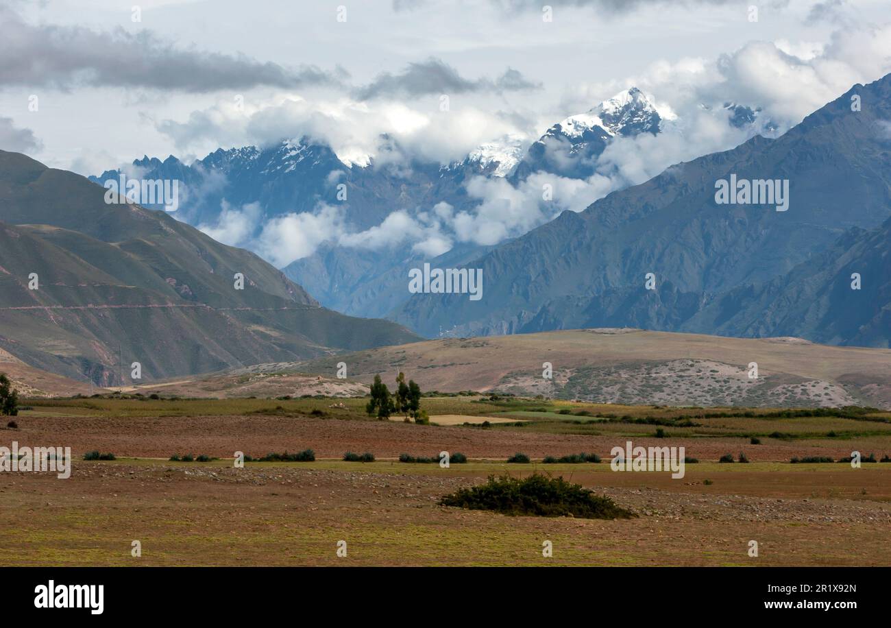 A view of the snow capped Andes Mountain range as seen from the farming land near Maras in Peru. Maras is a town in the Sacred Valley of the Incas. Stock Photo