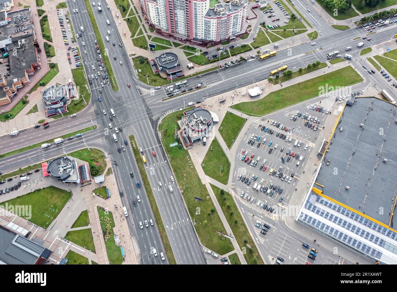 aerial city view with crossroads streets, apartment buildings, shopping mall and parking lots Stock Photo