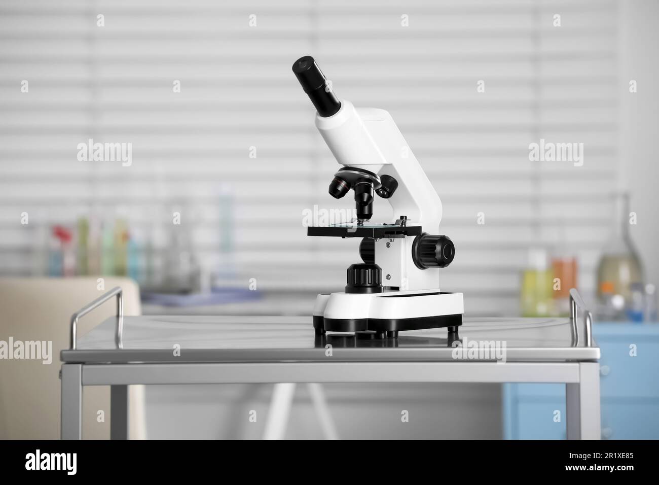 Modern medical microscope on metal table in laboratory Stock Photo - Alamy