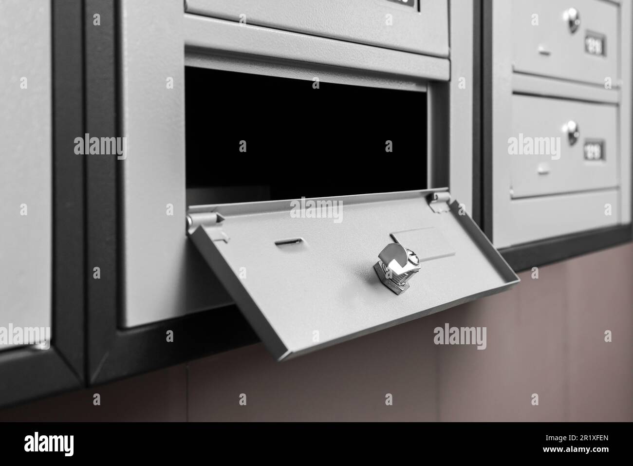 Open empty metal mailbox with keyhole indoors Stock Photo Alamy