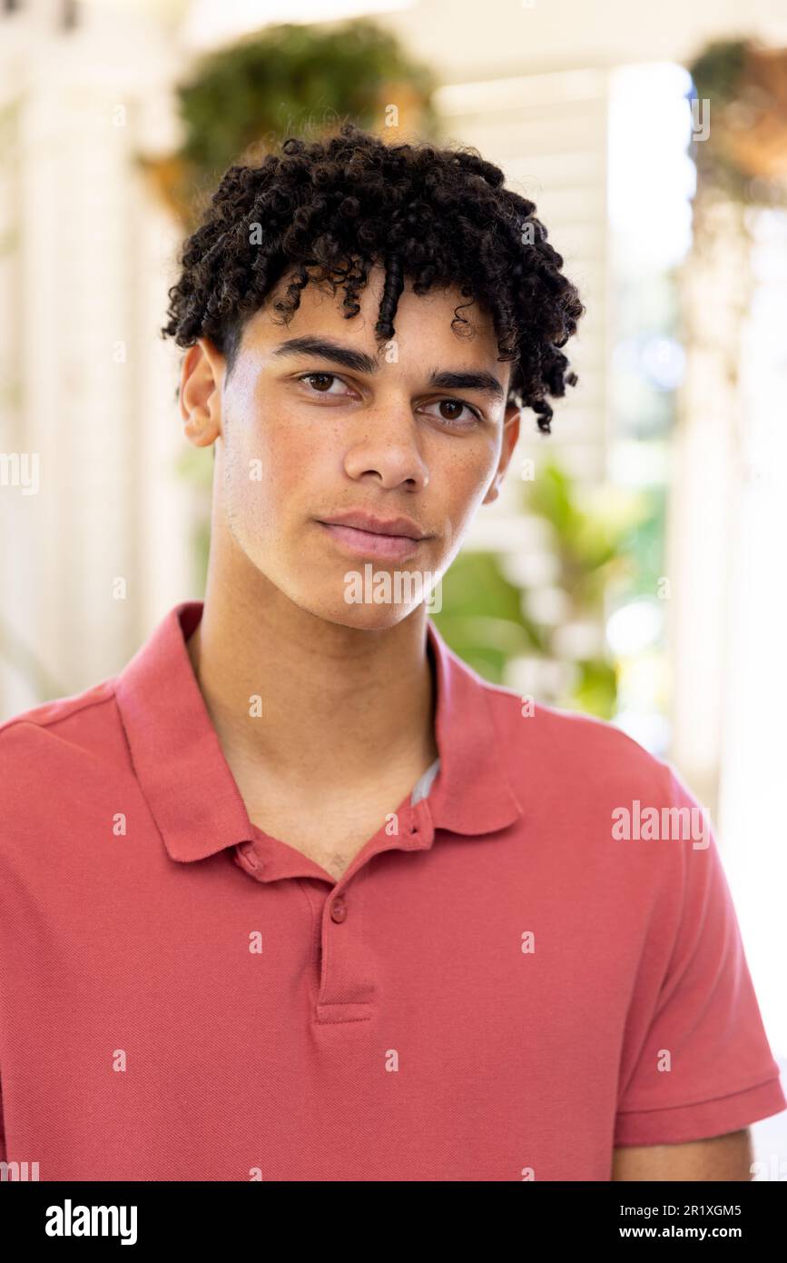 Portrait of happy biracial man with curly black hair at home Stock Photo
