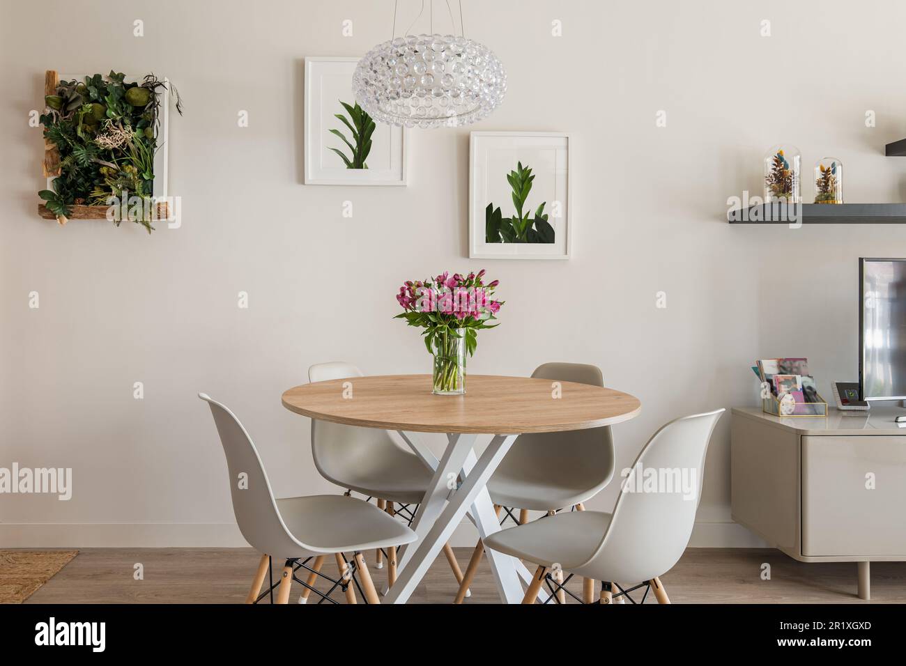 Cozy stylish living room with a round dining table, chairs and TV with ...
