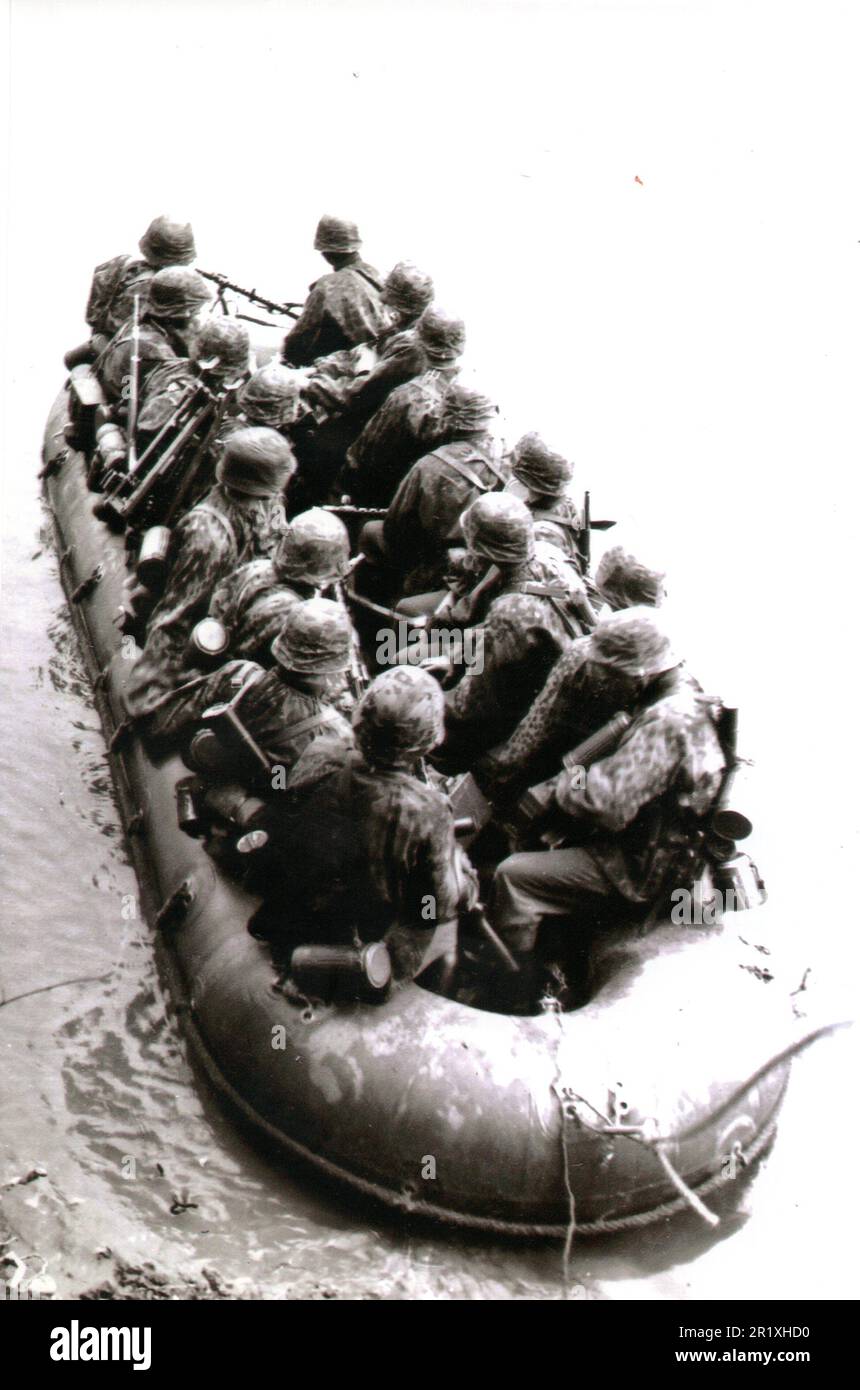 World War Two B&W photo German Troops in a Rubber Raft crossing a river on the Russian Front 1941 The Soldiers are from a Waffen SS Unit in their Camo Smocks and Helmet Covers Stock Photo