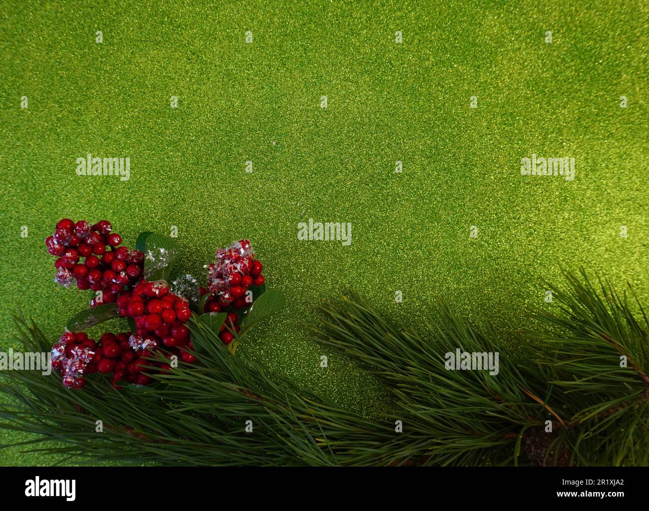 green christmas background with fir tree branch and christmas balls and ...