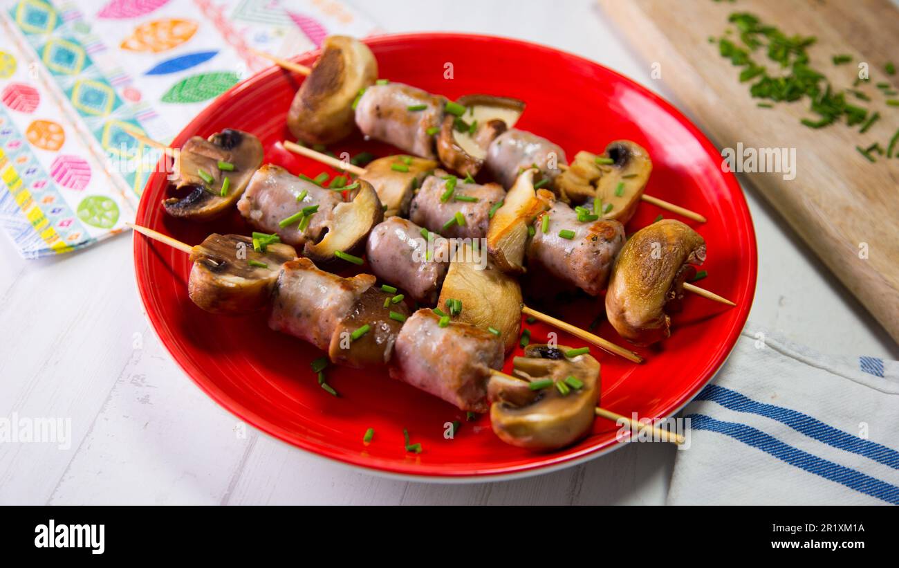 Pork sausage skewer with braised mushrooms Stock Photo Alamy