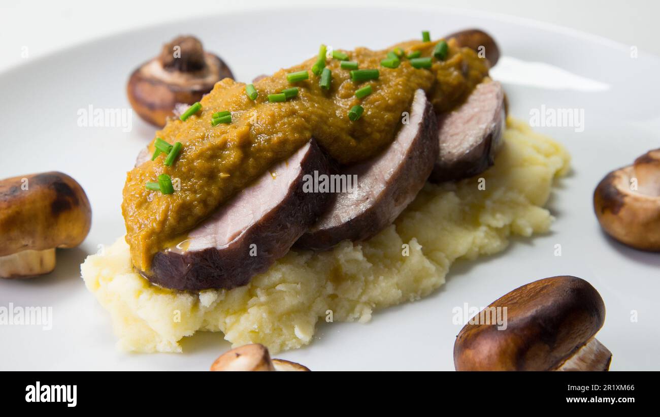 Pork tenderloin with cabbage puree and mushroom sauce Stock Photo - Alamy