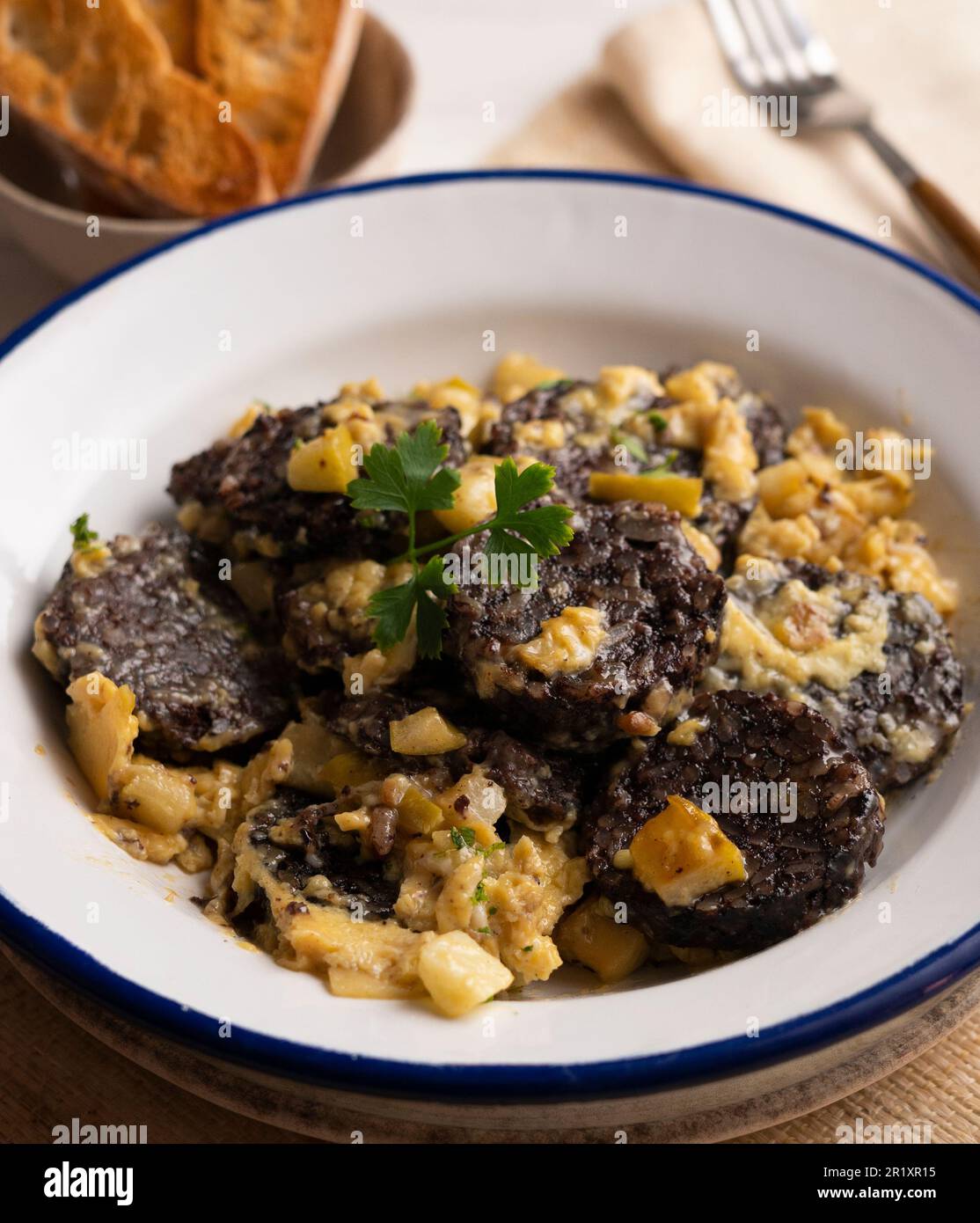 Scrambled with egg, young garlic and black blood sausage. Traditional ...