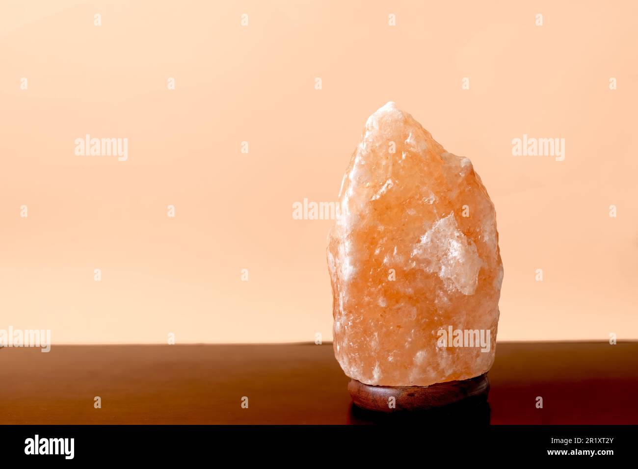 Himalayan salt lamp with the ability to ionize the air on a blue