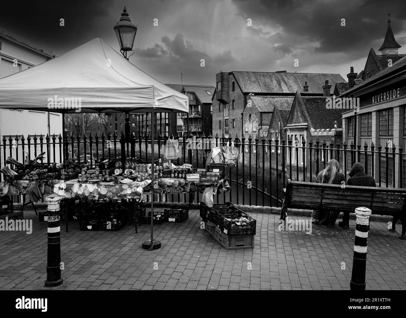 An atmospheric Black and white image of a market stall on the river bridge in Lewes East Sussex on a stormy day Stock Photo