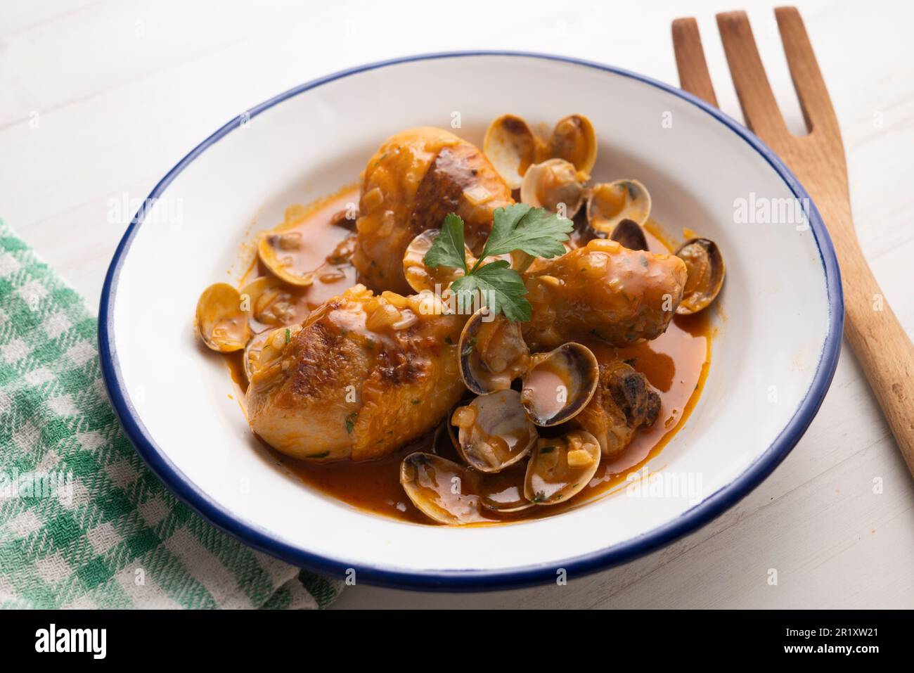Baked chicken thighs with clams. Traditional Spanish tapa Stock Photo