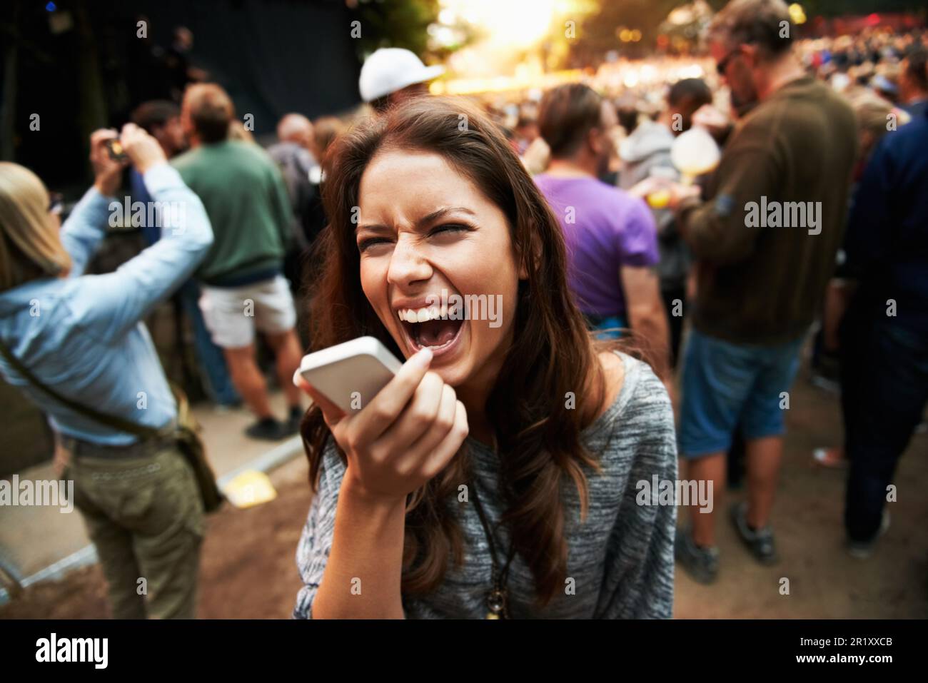 I cant hear you. A pretty young woman shouting into her smartphone at