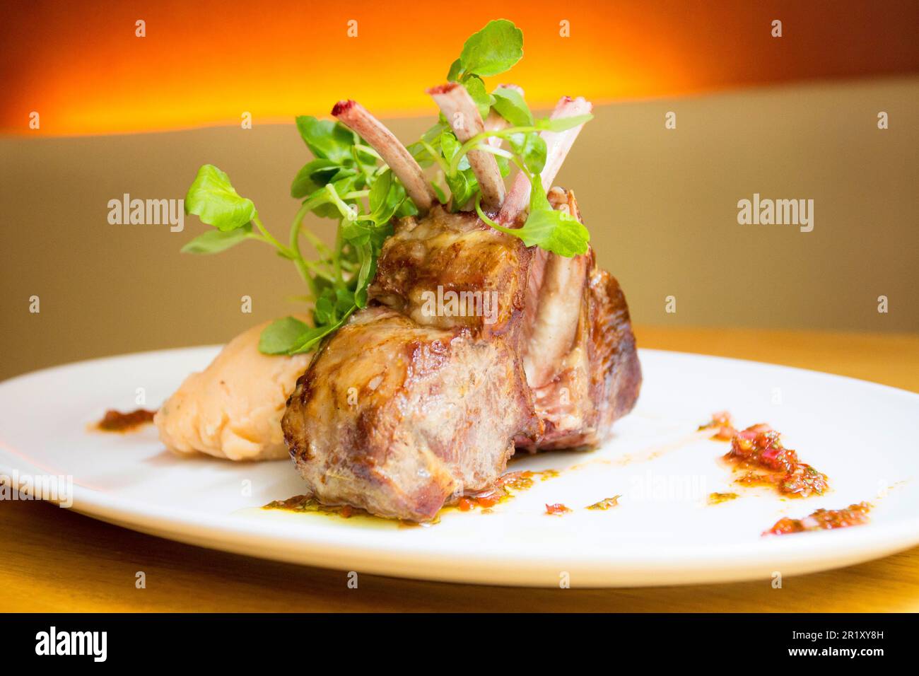 Lamb ribs in a restaurant in spain with some salad on the side. Stock Photo