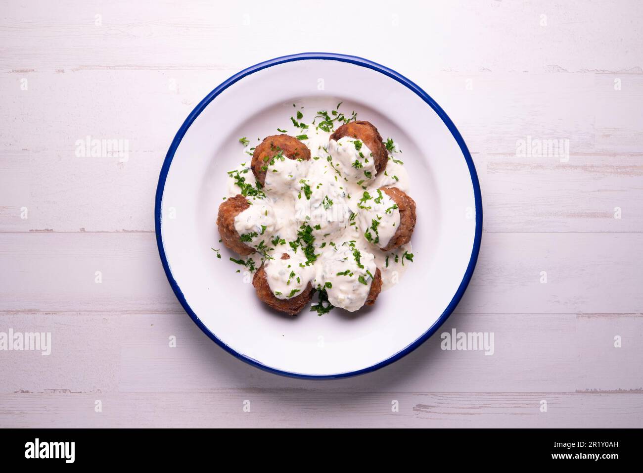 Greek meatballs with yogurt sauce. A meatball is a popular culinary