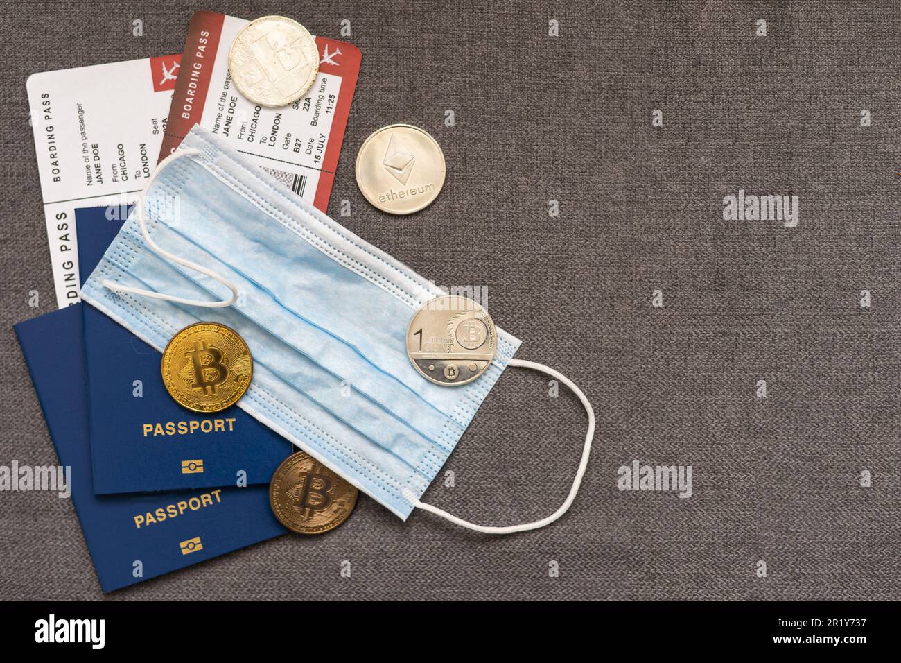 Passport, bitcoin, the airplane background. The concept of travel Stock