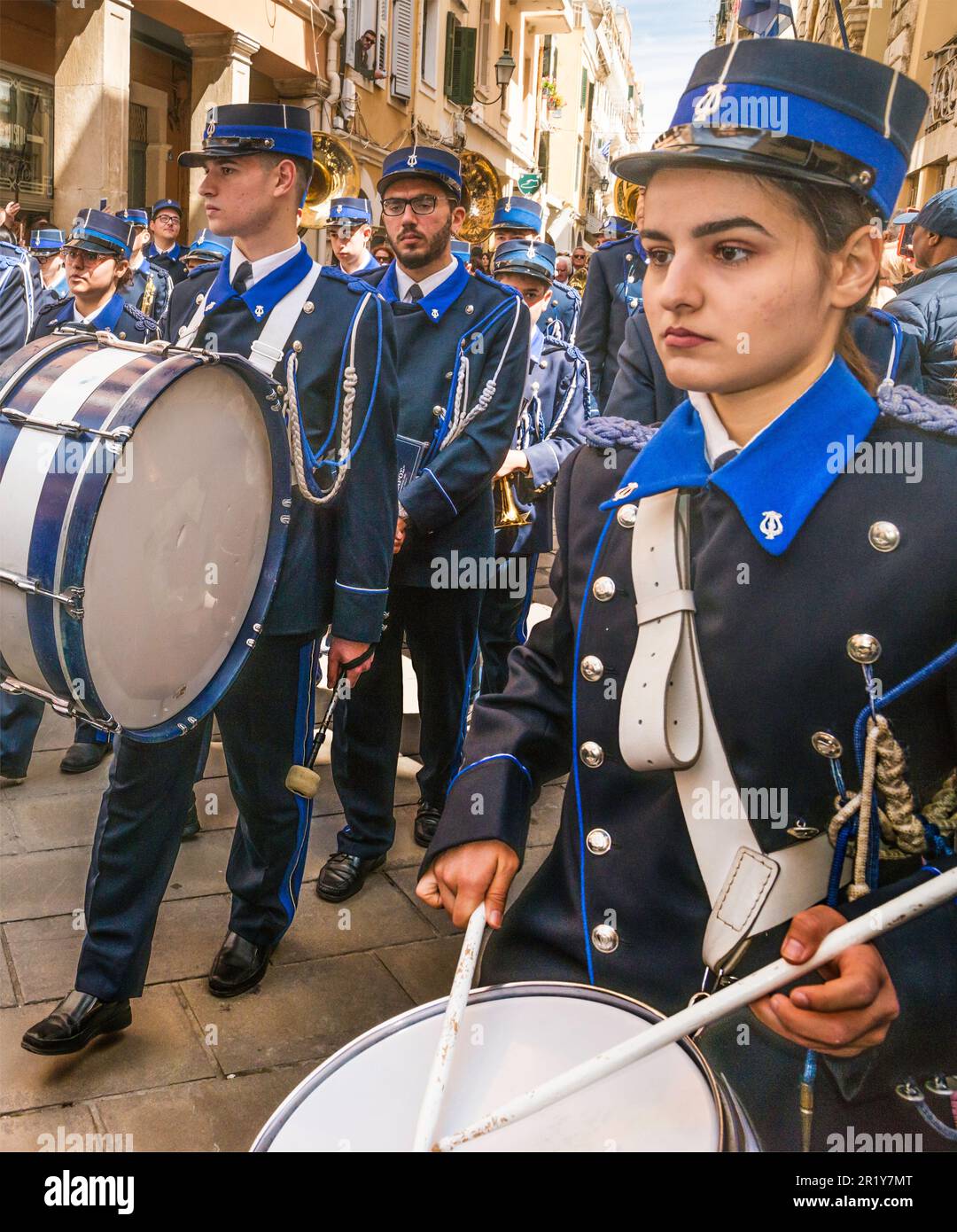 Young woman drummer, Mantzaros marching band performing at street in