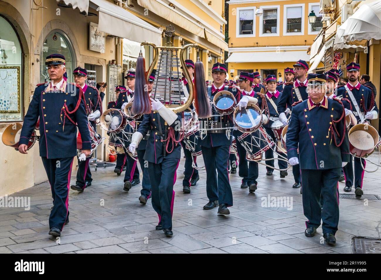 Marching band, lyre type instrument in center, performing in Holy Week at Nikiforou Theotoki street in Campiello (Old Town of Corfu) section, in town of Corfu, Corfu Island, Greece Stock Photo