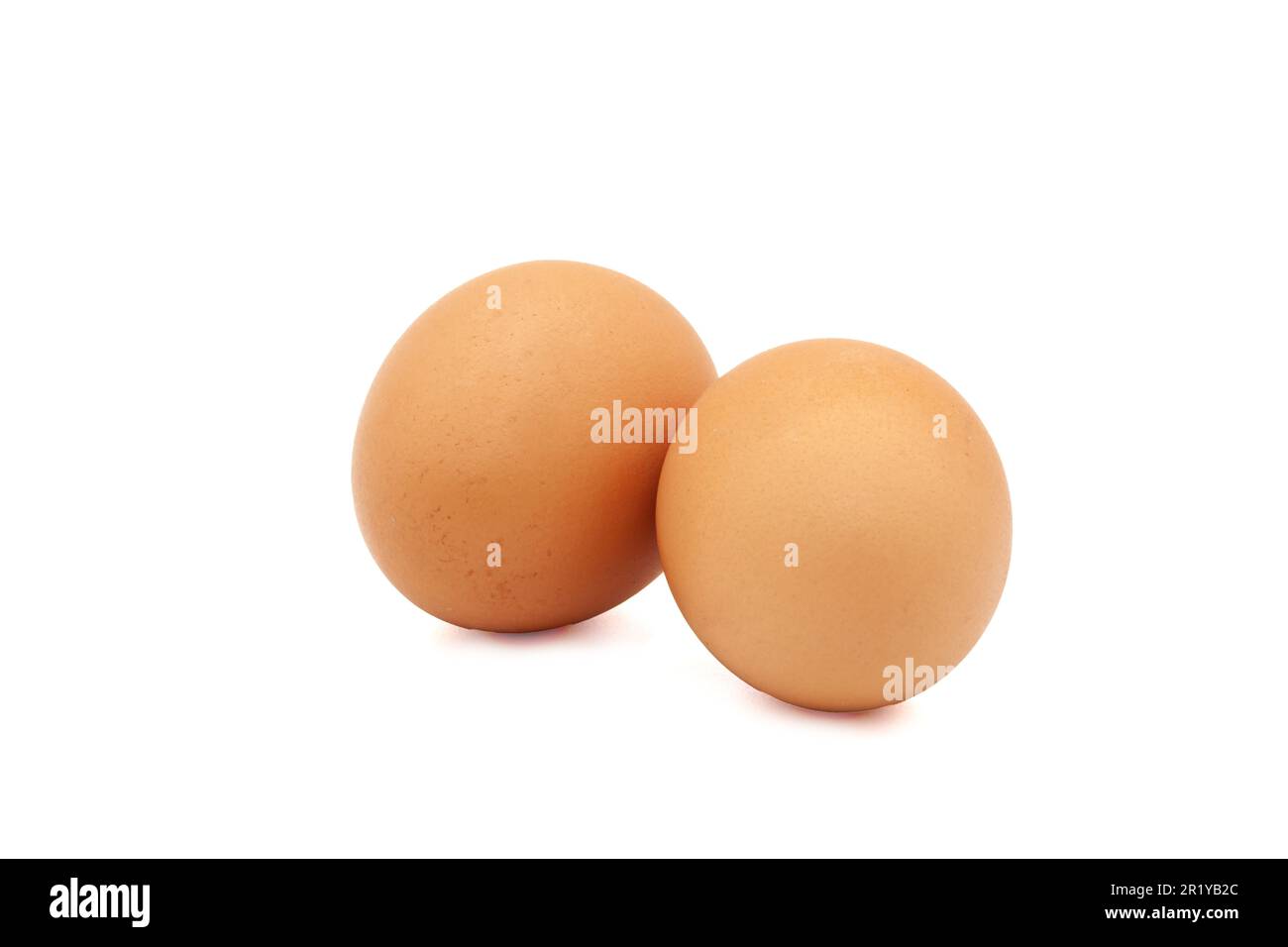Two brown eggs from a chicken on a white background. Isolated. Photo in high quality. Stock Photo